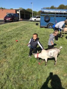 Special children are playing with a goat